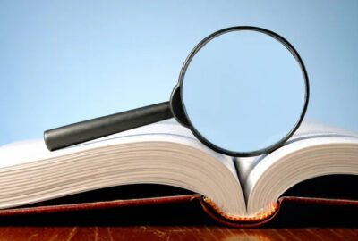 Depositphotos 8913595 stock photo book and a magnifying glass