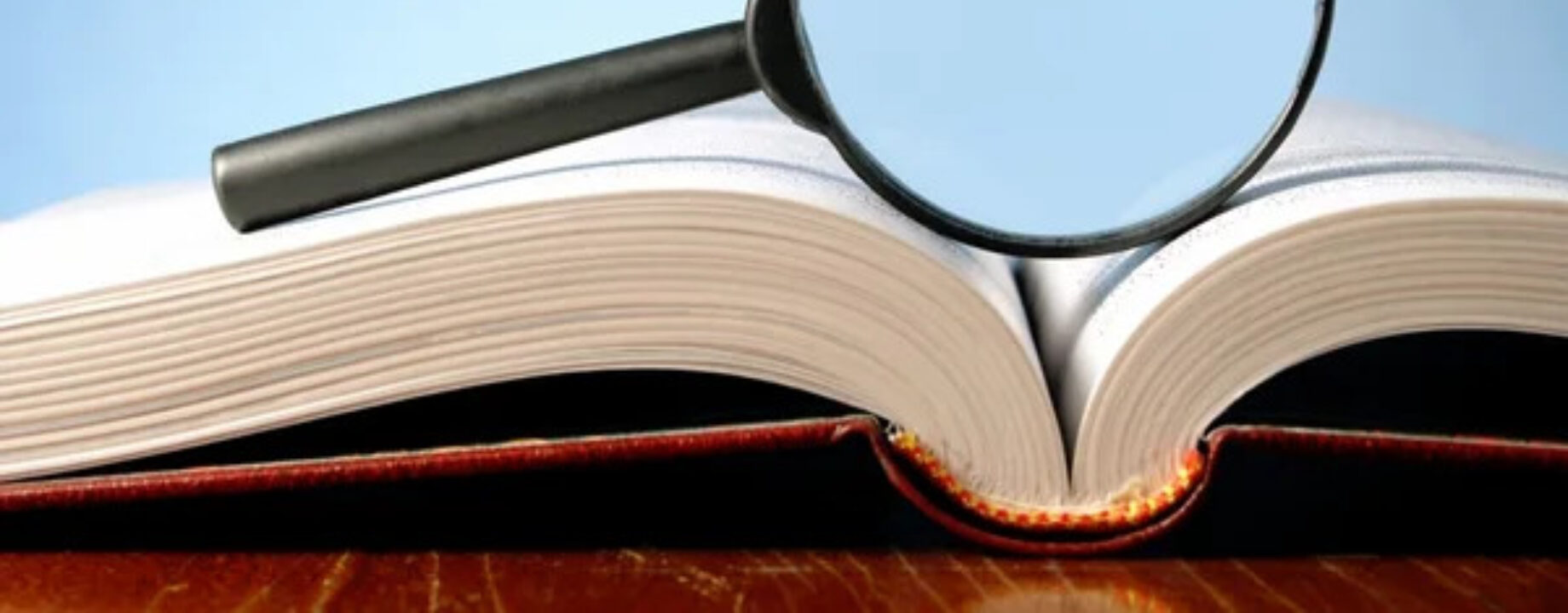 Depositphotos 8913595 stock photo book and a magnifying glass